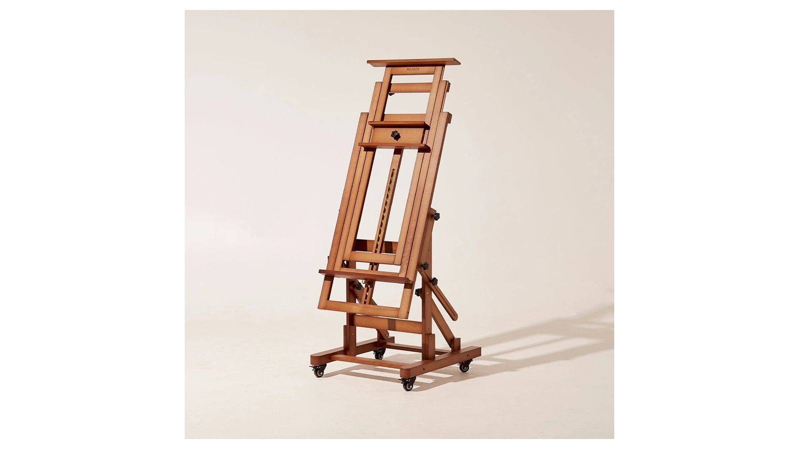 Full view of the MEEDEN Walnut DHJ-3 wooden H-frame easel on casters