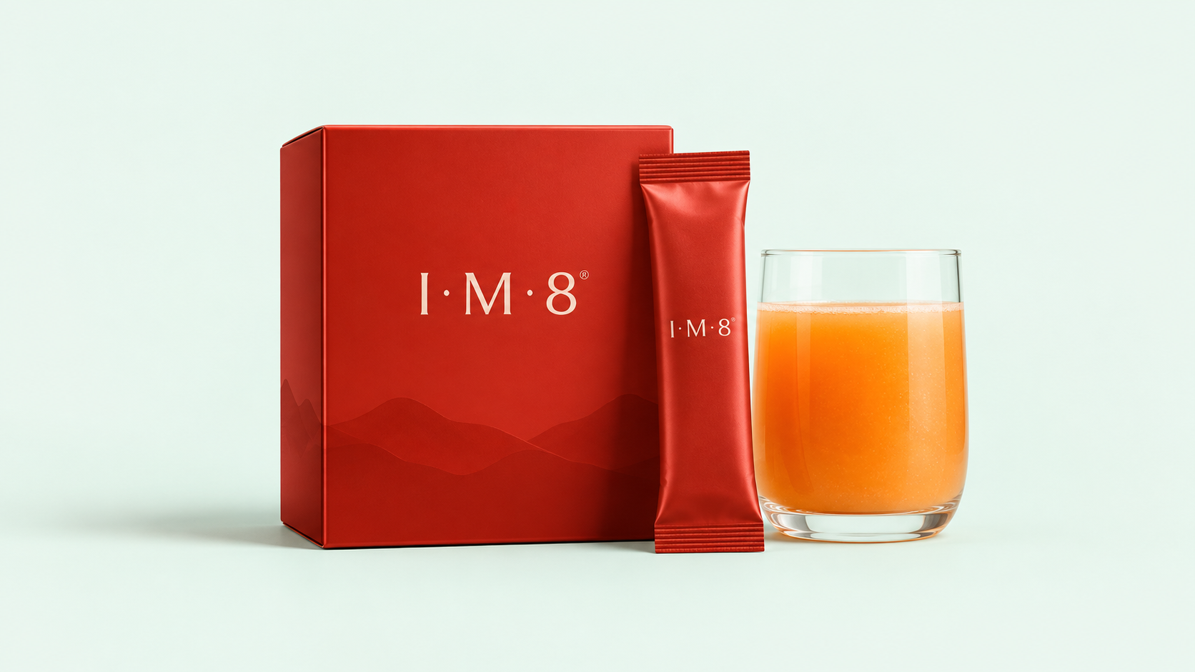 IM8 daily wellness supplement with sachet, product box, and prepared drink