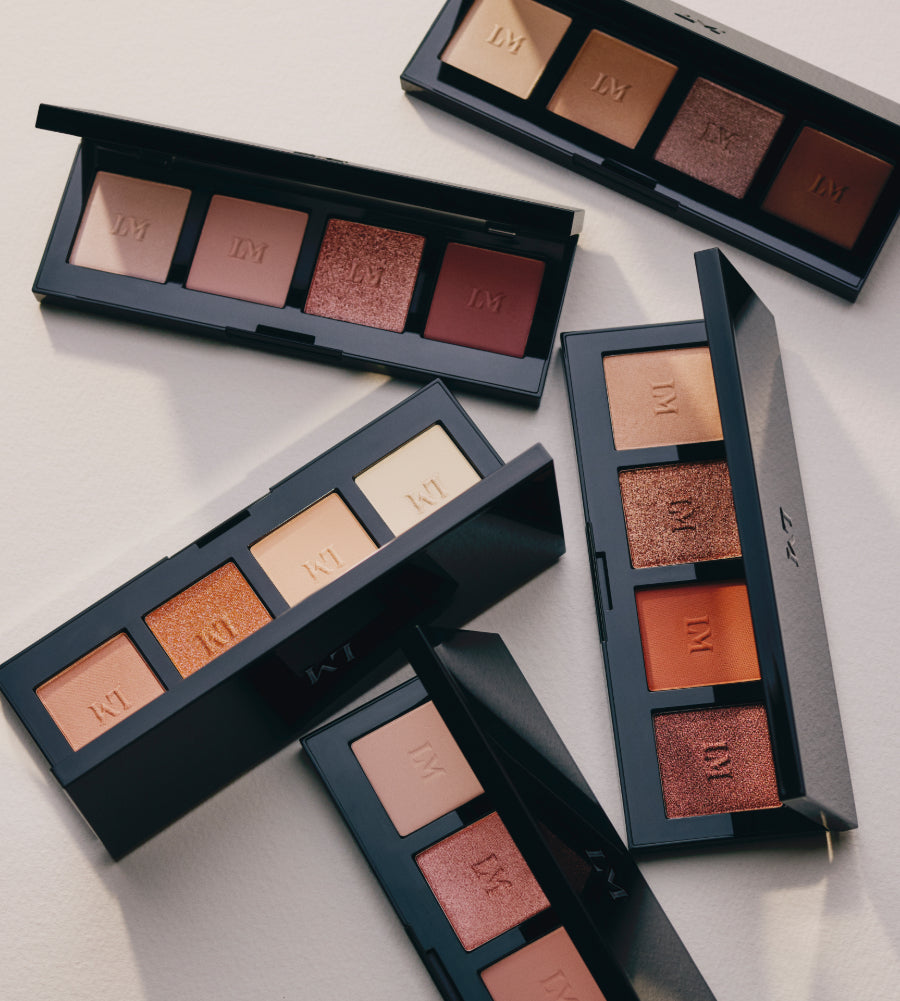 Laura Mercier eye shadow palettes arranged on a neutral background