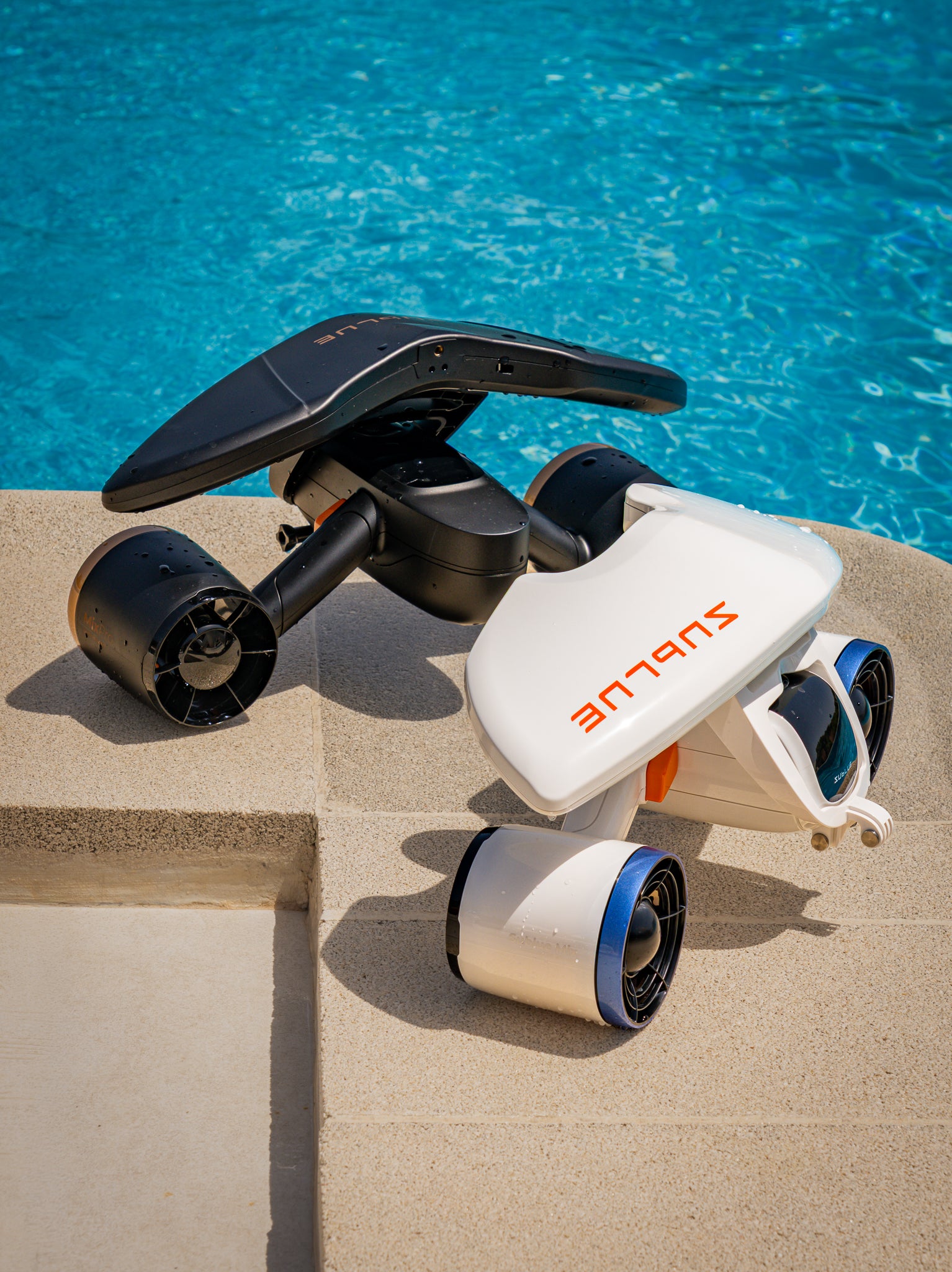 White and black SUBLUE scooters beside a swimming pool